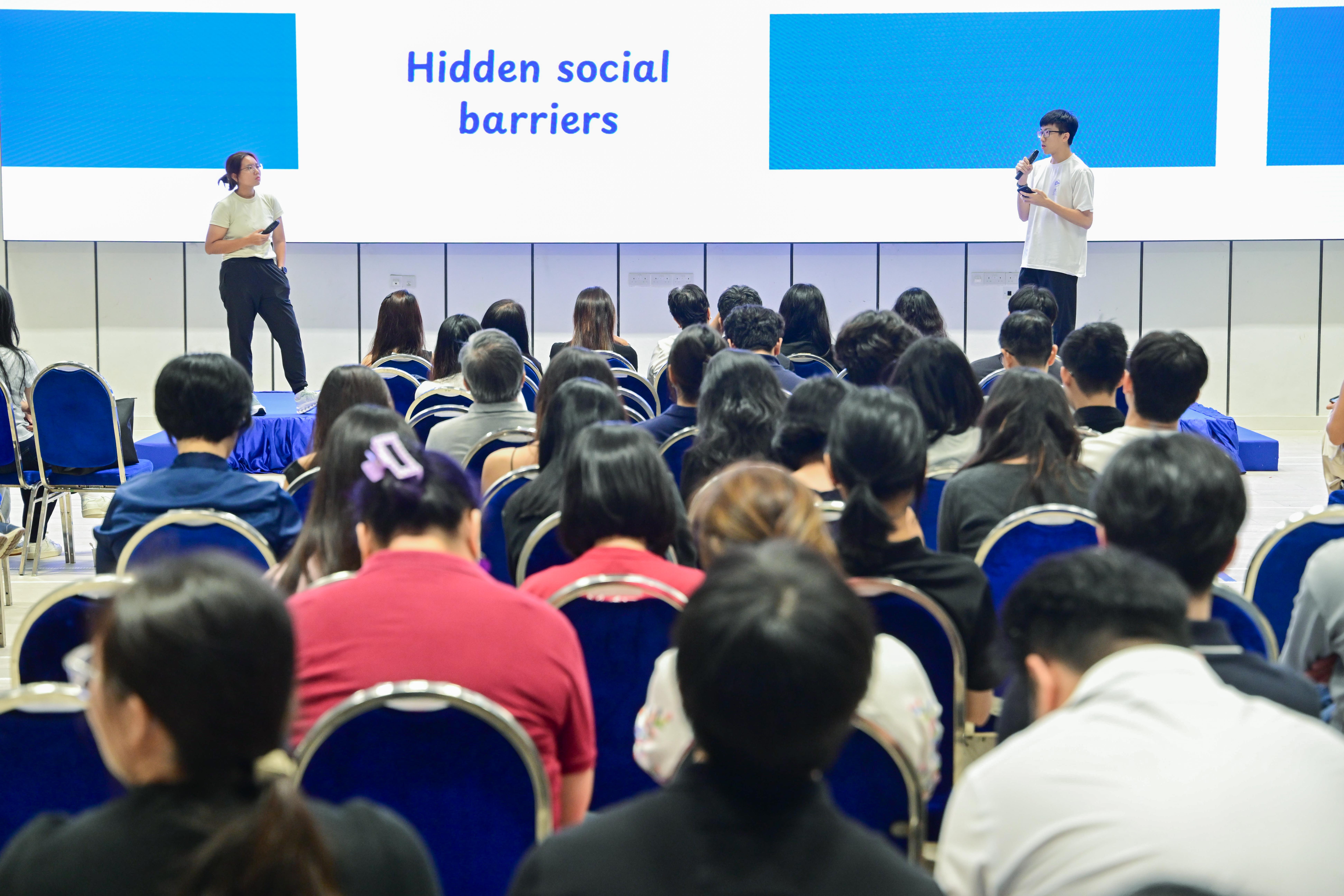 Two students explaining hidden social barriers